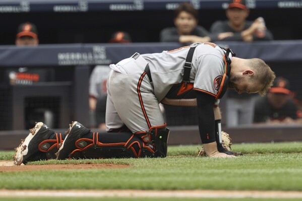 Baltimore Orioles catcher Maverick Handley reacts after colliding with New York Yankees' Jazz Chisholm Jr. during the second inning of a baseball game Sunday, June 22, 2025, in New York. (AP Photo/Pamela Smith)