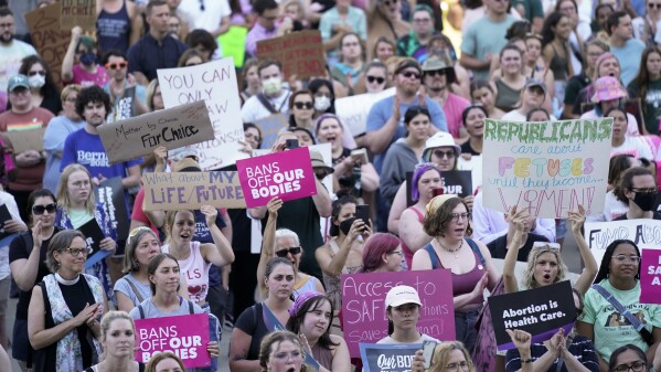 FILE - Abortion rights protesters attend a rally outside the state Capitol in Lansing, Mich., June 24, 2022, following the United States Supreme Court's decision to overturn Roe v. Wade. Two key pieces of legislation that would have repealed a 24-hour wait period required for patients receiving an abortion and also allowed state Medicaid dollars to pay for abortions were left out of a package signed Tuesday, Nov. 21, 2023, by Gov. Gretchen Whitmer. (AP Photo/Paul Sancya, File)