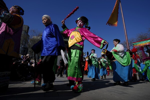 Chinese performers dressed in traditional costumes participate in a performance at the Dongyue Temple on the first day of the Chinese Lunar New Year in Beijing, Saturday, Feb. 10, 2024. (APPhoto/Andy Wong)