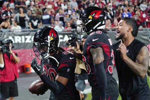 Arizona Cardinals cornerback Marco Wilson (20) celebrates his pick six touchdown interception with cornerback Antonio Hamilton and injured running back James Conner, right, during the first half of an NFL football game against the New Orleans Saints, Thursday, Oct. 20, 2022, in Glendale, Ariz. (AP Photo/Ross D. Franklin)