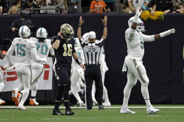 New Orleans Saints quarterback Ian Book (16) walks back to the bench after throwing an interception which was returned for a touchdown by Miami Dolphins' Nik Needham during the first half of an NFL football game Monday, Dec. 27, 2021, in New Orleans. (AP Photo/Derick Hingle)