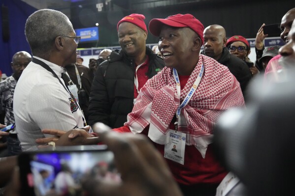 Economic Freedom Fighters (EFF) leader, Julius Malema, front center, arrives at the Results Operation Centre (ROC) in Midrand, Johannesburg, South Africa, Saturday, June 1, 2024. The African National Congress party has lost its parliamentary majority in a historic election result that puts South Africa on a new political path for the first time since the end of the apartheid system of white minority rule 30 years ago. (AP Photo/Themba Hadebe)