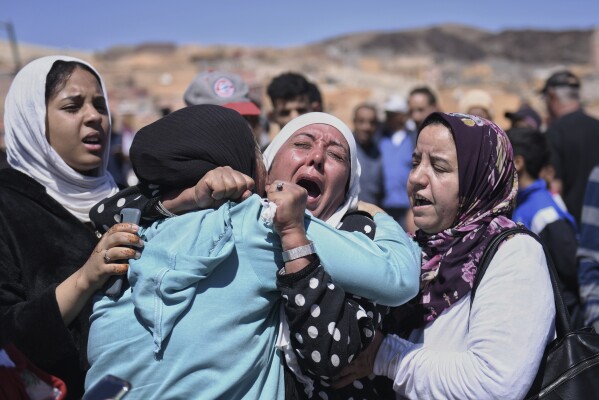 Women cry as they mourn victims of the earthquake in Moulay Brahim in the province of Al Haouz, Morocco, Sunday Sept. 10, 2023. (Fernando Sanchez/Europa Press via AP)