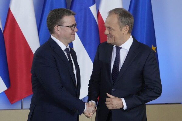 Polish Prime Minister Donald Tusk, right, shakes hands with Finnish Prime Minister Petteri Orpo, during their meeting at the Polish Prime Minister's office in Warsaw, Poland, Friday, Feb. 16, 2024. (AP Photo/Czarek Sokolowski)