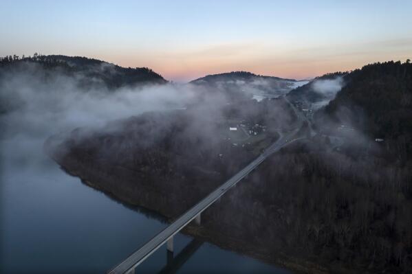In this aerial image taken from a drone, the city of Klamath, Calif., home of the tribal headquarters for the Yurok Tribe, dots the side of U.S. Highway 101 at sunrise on Jan. 21, 2022. The Native American tribe has issued an emergency declaration on human trafficking and missing women. There have been five instances in the past 18 months where Indigenous women have gone missing or been murdered between San Francisco and the Oregon border. (AP Photo/Nathan Howard)