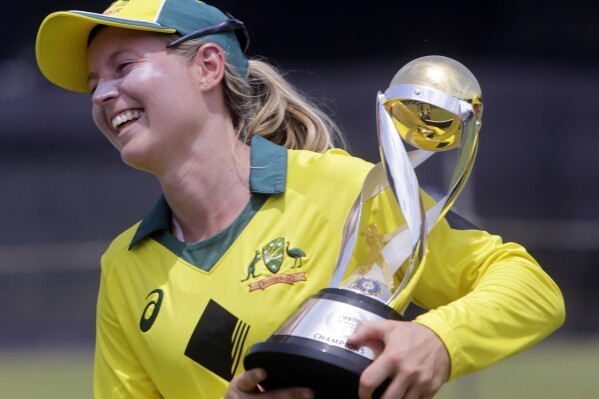 FILE - Australia's captain Meg Lanning with the trophy smiles after winning the final of Women's cricket T20 Triangular Series in Mumbai, India, Saturday, March. 31, 2018. Australia women's cricket captain Lanning has announced her international retirement after playing 241 matches 鈥� six tests, 103 one-day internationals and 132 Twenty20 matches.(AP Photo/Rajanish Kakade, File)