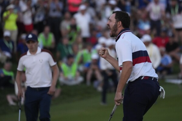 United States' Patrick Cantlay celebrates after holing his putt that led to him winning his afternoon Fourballs match on the 18th green at the Ryder Cup golf tournament at the Marco Simone Golf Club in Guidonia Montecelio, Italy, Saturday, Sept. 30, 2023. (AP Photo/Andrew Medichini)