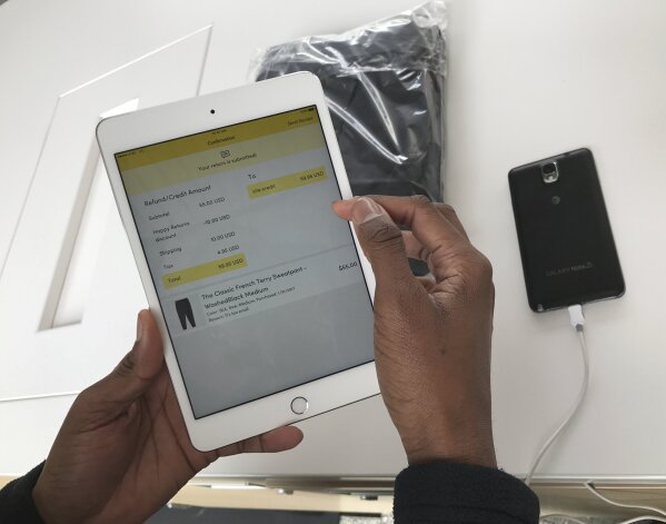 
              In this Monday, April 3, 2017, photo, Happy Returns "return-ista" Taj Sims processes a customer's return at the company's kiosk designed to make it easier for buyers of online merchandise to be returned, at the Santa Monica Place mall in Santa Monica, Calif. As online shopping surges, so do the returns, and the hassles for shoppers trying to get rid of items that aren't right. A few startups dedicated to online returns and changes at some big stores may make it easier. (AP Photo Damian Dovarganes)
            
