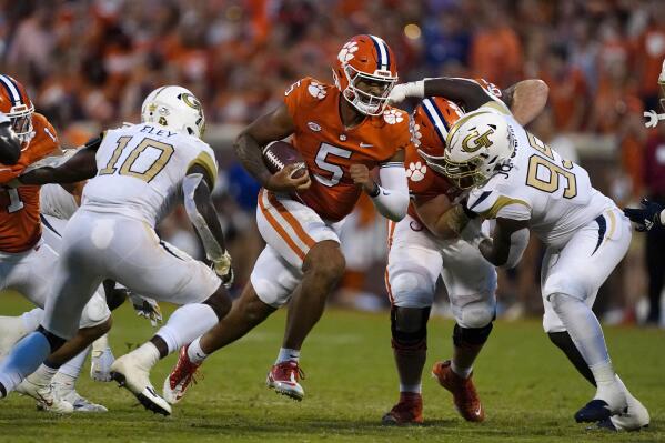 Clemson quarterback D.J. Uiagalelei (5) runs through the line as Georgia Tech's Ayinde Eley (10) and D'Quan Douse (99) close in during the second half of an NCAA college football game, Saturday, Sept. 18, 2021, in Clemson, S.C. (AP Photo/John Bazemore)