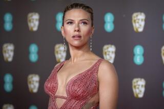 FILE - Scarlett Johansson arrives at the Bafta Film Awards, in central London, Feb. 2 2020. Johansson is suing the Walt Disney Co. over the company’s streaming release of "Black Widow," which she said breached her contract and deprived her of potential earnings. The “Black Widow” star and executive producer filed a suit Thursday, July 29, 2021, in the Los Angeles Superior Court that said her contract guaranteed an exclusive theatrical release. (Photo by Vianney Le Caer/Invision/AP, File)