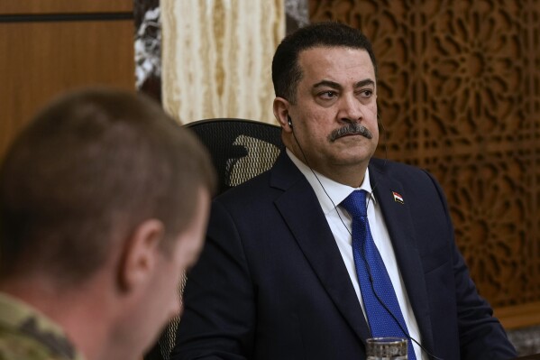 Iraqi Prime Minister Mohammed Shia al-Sudani, right, chairs the first session of negotiations between Iraq and the United States to wind down the International Coalition mission in Baghdad, Iraq, Saturday, Jan. 27, 2024. (AP Photo/Hadi Mizban, Pool)