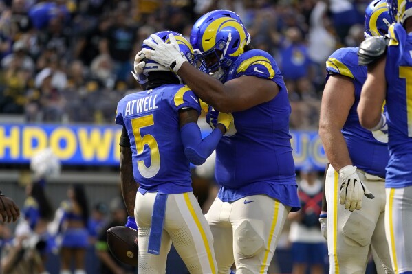 Los Angeles Rams guard Coleman Shelton, right, congratulates Rams wide receiver Tutu Atwell (5) after Atwell made a touchdown during the first half of an NFL football game against the Pittsburgh Steelers Sunday, Oct. 22, 2023, in Inglewood, Calif. (AP Photo/Ashley Landis)