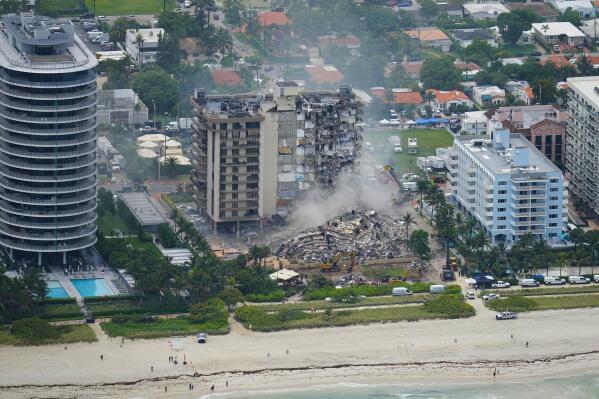 Rescue personnel work in the rubble at the Champlain Towers South Condo, Friday, June 25, 2021, in Surfside. The seaside condominium building partially collapsed on Thursday. (AP Photo/Gerald Herbert)
