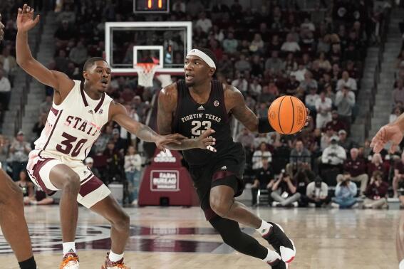 Texas A&M guard Tyrece Radford (23) dribbles up court while Mississippi State guard Shawn Jones Jr. (30) defends during the first half of an NCAA college basketball game in Starkville, Miss., Saturday, Feb. 25, 2023. (AP Photo/Rogelio V. Solis)