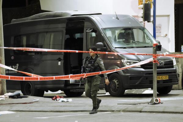An Israeli border police officer walks at the scene of a shooting attack near the Shuafat refugee camp in Jerusalem, Saturday, Oct. 8, 2022. Israeli police say armed assailants have opened fire at an Israeli military checkpoint in east Jerusalem, seriously wounding at least two people. (AP Photo/Mahmoud Illean)
