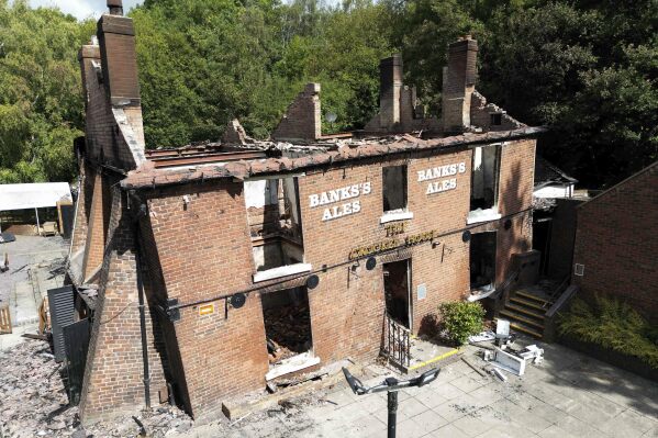 The burnt out remains of The Crooked House pub near Dudley, England, on July 8,, 2023. The owners of a quirky 18th century British pub destroyed in a fire last year have been ordered by a local council to rebuild it, keeping with its previous lopsided specifications. The watering hole — known as the Crooked House for its leaning walls and tilting foundation — in the village of Himley in central England, was gutted by a fire and subsequently demolished last August. (Jacob King/PA via AP)