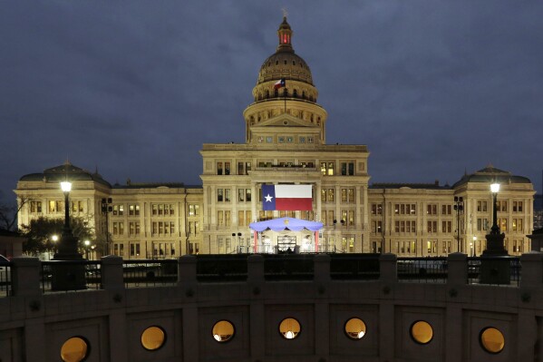 FILE - In this Jan. 14, 2019 file photo, a large Texas flag hangs from the Texas State Capitol in Austin, Texas. A federal judge has struck down a Texas law requiring age verification and health warnings to view pornographic websites and blocked the state attorney general's office from enforcing it. U.S. District Judge David Ezra on Thursday, Aug. 31, 2023 agreed with claims that the bill signed into law by Gov. Greg Abbott in June violates free speech rights, is overbroad and vague.(AP Photo/Eric Gay, File)