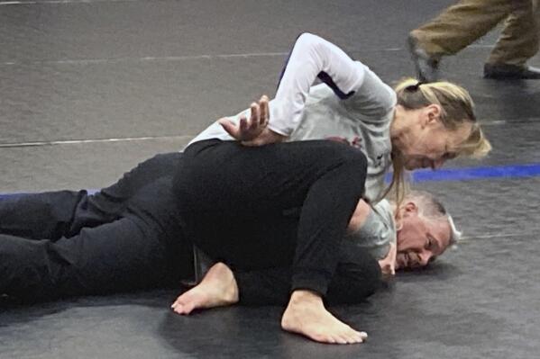 Eve Steffans of the Martial Arts Academy in Billings, Montana, practices judo techniques on Ed Thompson, a retired police officer, during a training session, March 9, 2021, in Douglas, Wyoming. USA Judo is holding workshops with police departments across the country to introduce them to judo techniques that could lessen the need for deadly force when officers have to apprehend people on the streets. (AP Photo/Eddie Pells)