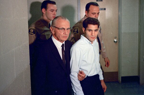 
              FILE - This June 1968 file photo shows Sirhan Sirhan, right, a suspect of shooting Sen. Robert F. Kennedy, with his attorney Russell E. Parsons in Los Angeles. Associated Press Hollywood reporter Bob Thomas was on a one-night political assignment in June 1968 to cover Kennedy’s victory in the California presidential primary when mayhem unfolded before his eyes. (AP Photo/File)
            