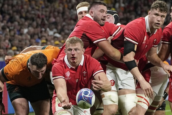 Wales' Jac Morgan passes the ball during a Rugby World Cup Pool C match against Australia at the Parc OL stadium in Lyon, France, Sunday, Sept. 24, 2023. (AP Photo/Laurent Cipriani)