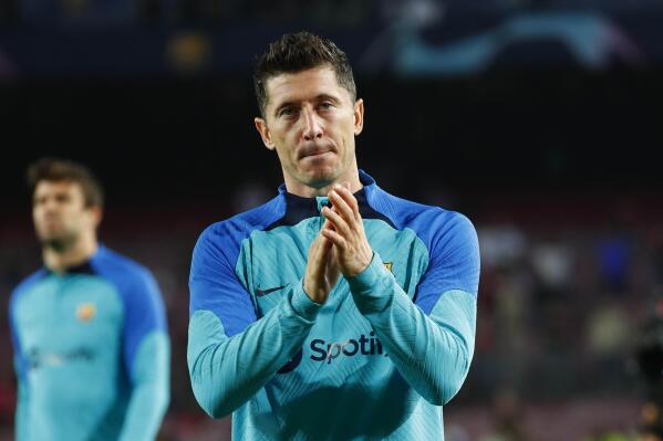 FILE - Barcelona's Robert Lewandowski applauds fans at the end of their Champions League Group C soccer match against Bayern Munich at the Camp Nou stadium in Barcelona, Spain, Oct. 26, 2022. Barcelona says that Lewandowski will be allowed to play their derby against Espanyol on Sunday, Dec. 31 after a court temporarily lifted his three-game suspension on appeal. (AP Photo/Joan Monfort, file)