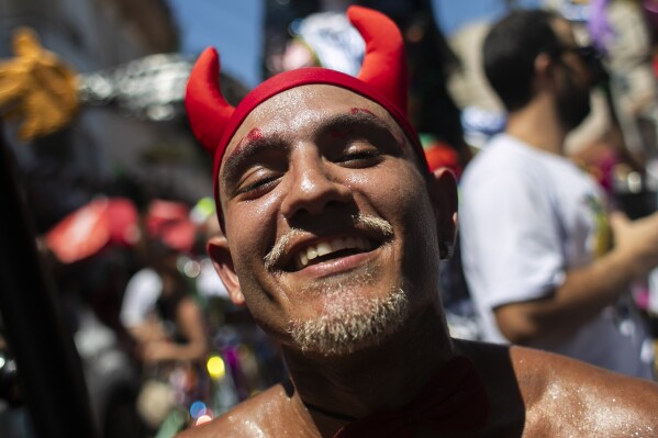 A reveler dressed as a devil attends the Carmelitas street party on the first day of Carnival in Rio de Janeiro, Brazil, Friday, Feb. 9, 2024. (AP Photo/Bruna Prado)