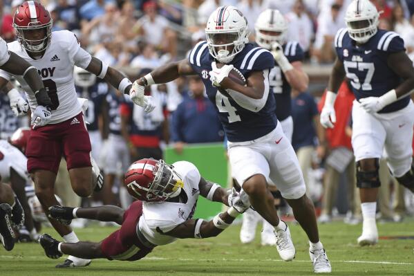 Mississippi running back Quinshon Judkins (4) runs the ball past Troy safety Craig Slocum Jr. (4) during the first half an NCAA college football game in Oxford, Miss., Saturday, Sept. 3, 2022. (AP Photo/Thomas Graning)