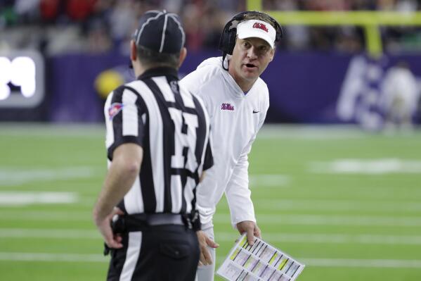 Mississippi coach Lane Kiffin talks with an official about a penalty call during the first half of the team's Texas Bowl NCAA college football game against Texas Tech on Wednesday, Dec. 28, 2022, in Houston. (AP Photo/Michael Wyke)