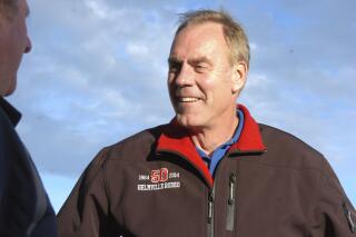 FILE - In this Oct. 20, 2016, file photo, then-Republican U.S. Rep. Ryan Zinke speaks with a supporter in Billings, Mont., as he campaigns for re-election to a second term as the state's sole representative in the U.S. House. The former congressman and interior secretary has filed paperwork with the Federal Election Commission indicating he's interested in running for the second U.S. House seat awarded to the state on Monday, April 26, 2021. (AP Photo/Matthew Brown, File)