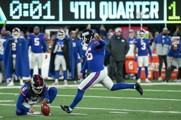 New York Giants place kicker Randy Bullock (46) kicks a field goal against the Green Bay Packers with one second remaining during the fourth quarter of an NFL football game, Monday, Dec. 11, 2023, in East Rutherford, N.J. The kick was good giving the Giants the win. (AP Photo/Seth Wenig)