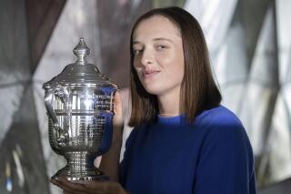 FILE - U.S. Open women's singles tennis champion Iga Swiatek poses at "Top of the Rock," in New York's Rockefeller Center, Monday, Sept. 12, 2022, in New York. Top-ranked Iga Swiatek will not play for Poland in the Billie Jean King Cup and complained Monday, Oct. 3, 2022, about that event being scheduled too close to the WTA Finals. (AP Photo/Yuki Iwamura, File)