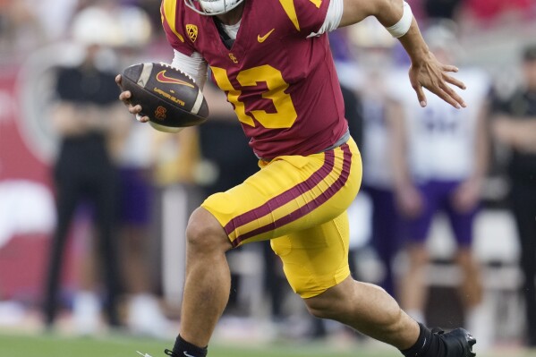 FILE - Southern California quarterback Caleb Williams (13) runs during the first half of an NCAA college football game against Washington Saturday, Nov. 4, 2023, in Los Angeles. Williams is expected to be taken in the first round of the NFL Draft. (AP Photo/Marcio Jose Sanchez, File)
