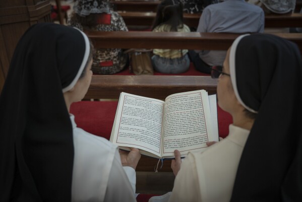 Chaldean nuns attend a service in the Mar Youssef Cathedral in Irbil, Iraq, on Sunday, July 30, 2023. Today, the number of Christians in Iraq is 150,000, compared to 1.5 million in 2003. (AP Photo/Julia Zimmermann/Metrography)