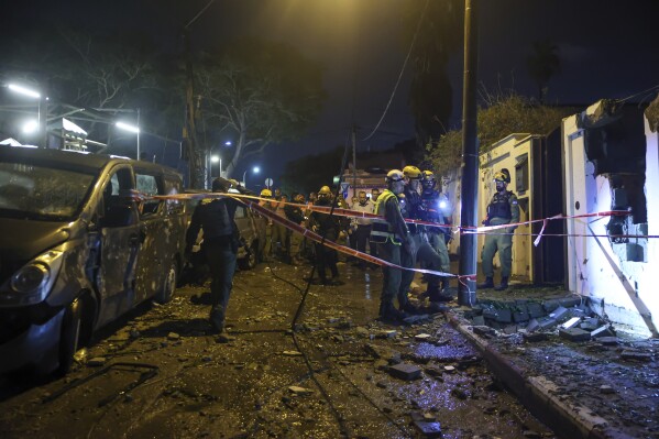 Israeli security forces inspect the site hit by a rocket fired from the Gaza Strip, in Jaffa, a mixed Arab-Jewish area of Tel Aviv, Israel, Tuesday, Nov. 14, 2023. (AP Photo/Itai Ron)