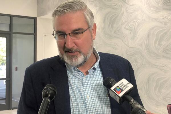 FILE - Indiana Gov. Eric Holcomb speaks with reporters during the Indiana Technology and Innovation Association conference in Fishers, Ind., on Friday, Oct. 8, 2021.   President Joe Biden’s plan to require vaccinations at all private employers of 100 workers or more has already hit a wall of opposition from Republican governors, state lawmakers and attorneys general.  (AP Photo/Tom Davies, File)