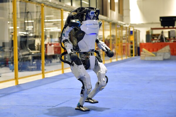 A Boston Dynamics Atlas robot performs a movement during a demonstration, Wednesday, Jan. 13, 2021, at the company's facilities in Waltham, Mass. The company engineered the robot to be able to dance in a fluid manner that is almost human. (AP Photo/Josh Reynolds)