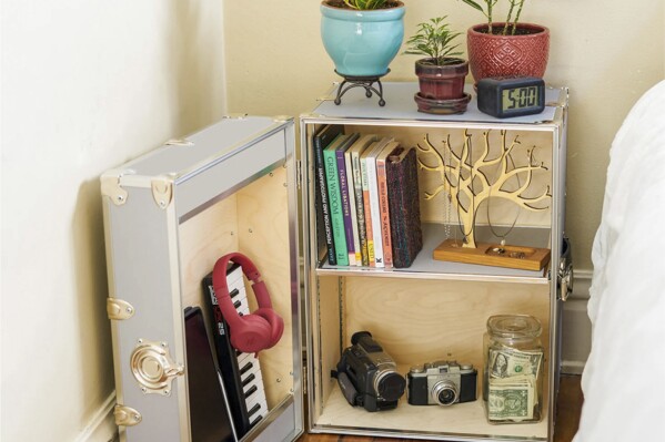 This image provided by Dormify shows a side table. The classic trunk is downsized and transformed into a side table, complete with lockable storage for valuables. (Dormify via AP)