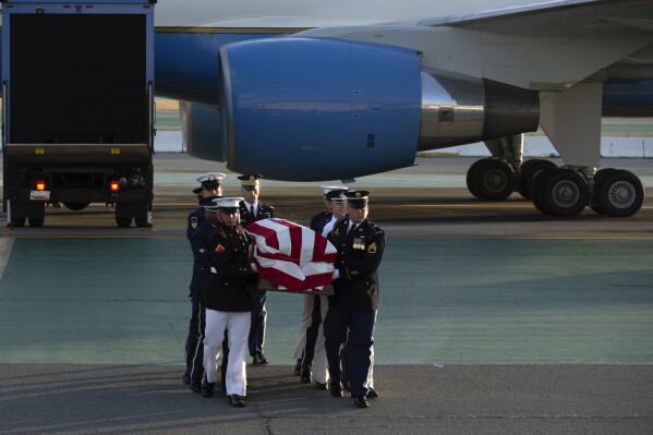 An armed forces color guard carries a casket containing the body of U.S. Sen. Dianne Feinstein, D-Calif., at San Francisco International Airport, Saturday, Sept. 30, 2023, in San Francisco. (AP Photo/D. Ross Cameron)