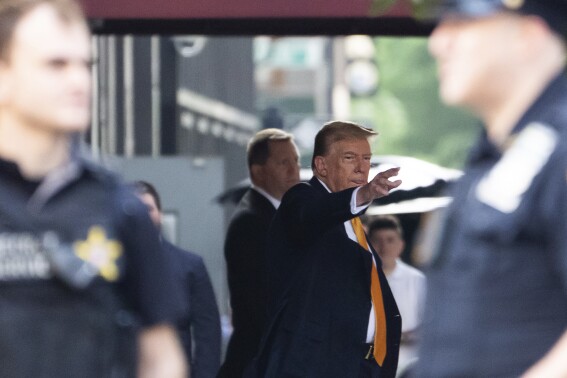Former president Donald Trump waves while leaving Trump Tower on his way to Manhattan criminal court, Tuesday, May 21, 2024, in New York. (AP Photo/Julia Nikhinson)