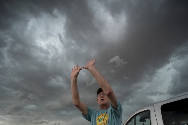 Retired National Weather Service forecaster David Imy gestures to an approaching storm during a Project ICECHIP operation Tuesday, June 3, 2025, near Tipton, Okla. (AP Photo/Carolyn Kaster)