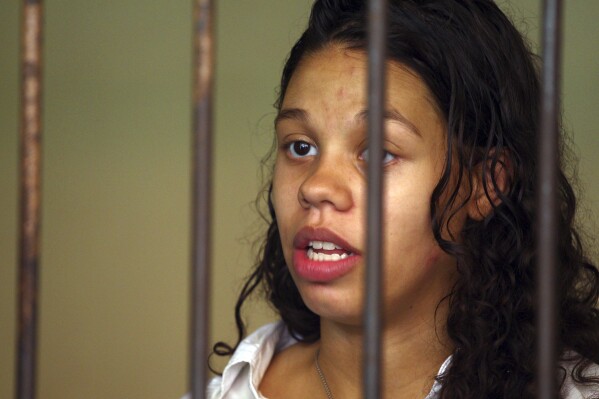 FILE - Heather Mack from Chicago, Ill., stands inside a cell before a trial in Bali, Indonesia, Wednesday, March 11, 2015. Mack, who pleaded guilty to helping kill her own mother and stuffing the body in a suitcase during a luxury vacation in Bali was sentenced by a federal judge, Wednesday, Jan. 17, 2024, to 26 years in prison. (AP Photo/Firdia Lisnawati, File)