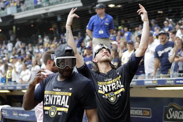 Milwaukee Brewers' Josh Hader, right, gestures to fans as he walks back onto the field after a baseball game against the New York Mets, Sunday, Sept. 26, 2021, in Milwaukee. The Brewers clinched the National League Central Division. (AP Photo/Aaron Gash)