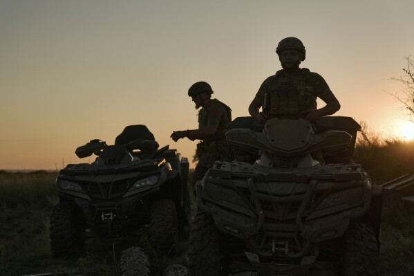 Ukrainian soldiers ride all-terrain vehicles at the front line near Bakhmut, one of the longest battles with Russian troops, Ukraine, Monday, Aug. 14, 2023. (AP Photo/Libkos)