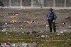 A law enforcement officer surveys the scene after a shooting during the Kansas City Chiefs NFL Super Bowl celebration in Kansas City, Mo., Wednesday, Feb. 14, 2024. Multiple people were injured, a fire official said.  (AP Photo/ Charlie Riddell)