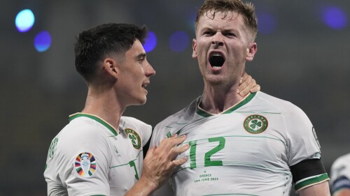 Ireland's Nathan Collins, right, celebrates after scoring his side's opening goal during the Euro 2024 group B qualifying soccer match between Greece and Ireland at the OPAP Arena in Athens, Greece, Friday, June 16, 2023. (AP Photo/Petros Giannakouris)