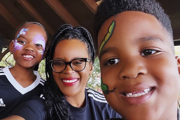 This image provided by Lakesha Cole shows Kirby, Lakesha and Keegan Cole during winter school break on December 30, 2022, at Legoland in Winter Haven, Fla. Family fun and a flexible schedule are priorities during school breaks, but Cole begins putting systems in place to organize her home and get her kids on an early bedtime schedule ahead of the first day of school. (Lakesha Cole via AP)