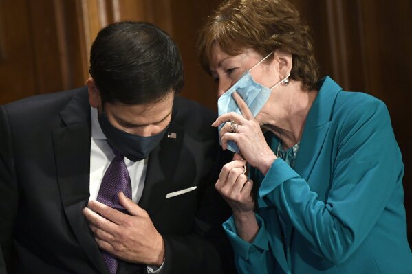 Sen. Marco Rubio, R-Fla., left, and Sen. Susan Collins, R-Maine, right, talk during a news conference on on Capitol Hill in Washington, Monday, July 27, 2020, to highlight the new Republican coronavirus aid package. Unemployment assistance, eviction protections and other relief for millions Americans are at stake as White House officials agreed Monday to launch negotiations with House Speaker Nancy Pelosi on a new coronavirus aid package that's teetering in Congress ahead of looming deadlines. (AP Photo/Susan Walsh)