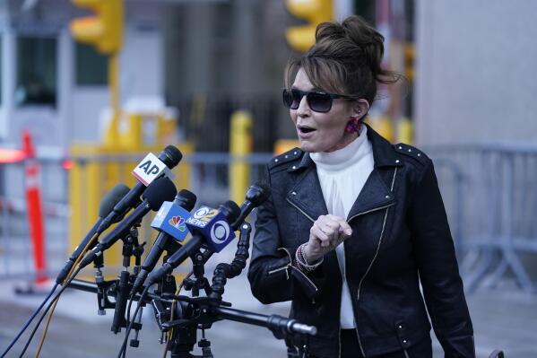 Former Alaska Gov. Sarah Palin speaks briefly to reporters as she leaves a courthouse in New York, Monday, Feb. 14, 2022. A judge said Monday he’ll dismiss a libel lawsuit that Palin filed against The New York Times, claiming the newspaper damaged her reputation with an editorial falsely linking her campaign rhetoric to a mass shooting. U.S. District Judge Jed Rakoff made the ruling with a jury still deliberating at the trial where the former Alaska governor and vice-presidential candidate testified last week. (AP Photo/Seth Wenig)