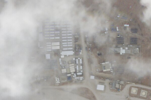 A satellite photo from Planet Labs PBC shows a military base known as Tower 22 in northeastern Jordan on Monday, Jan. 29, 2024. A satellite image taken Monday of the Jordanian base targeted by a bomb-carrying drone that killed three U.S. soldiers appears to show damage at the site. The damage can be seen in the center left of the photo. (Planet Labs PBC via AP)