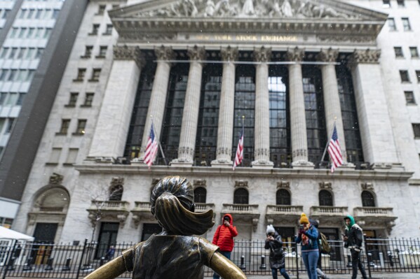 FILE - People photograph the Fearless Girl statue outside the New York Stock Exchange on Jan. 19, 2024, in New York. (APPhoto/Peter K. Afriyie, File)